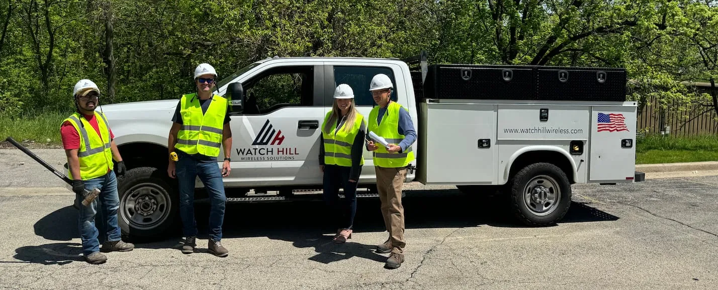 Watch Hill team beside a company truck