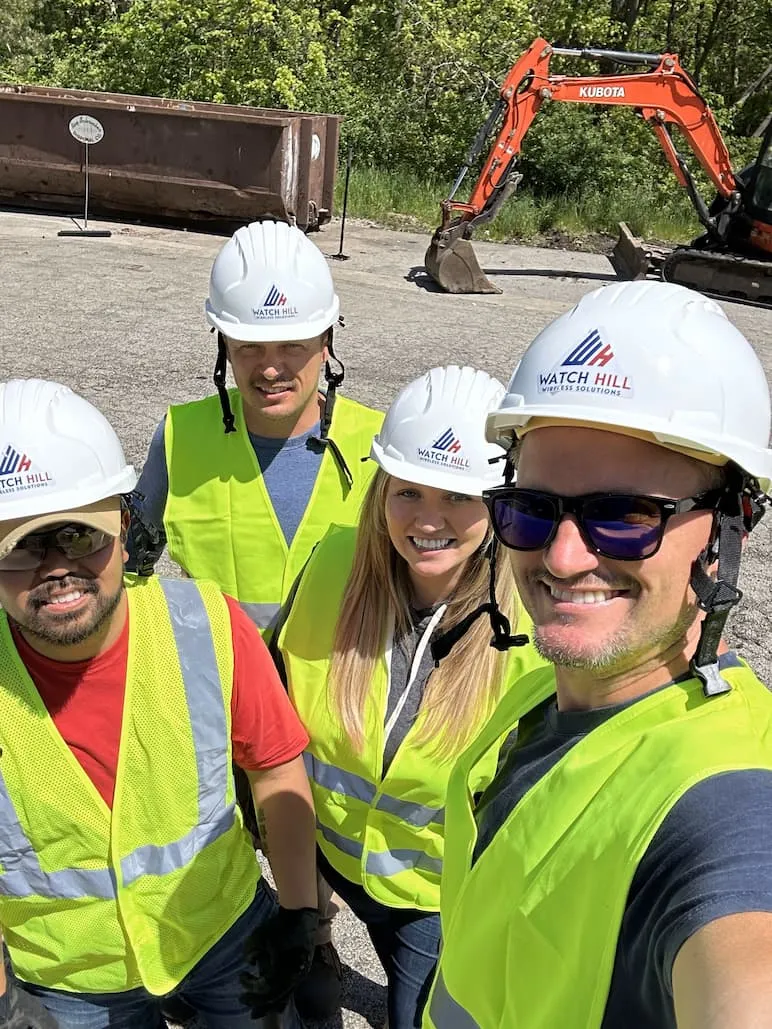 Watch Hill team members on site in hard hats and safety vests