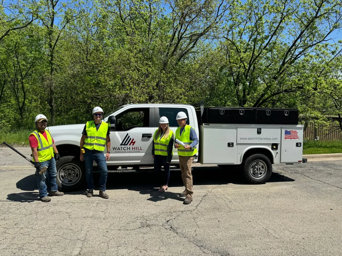 Watch Hill site development team beside a company utility truck