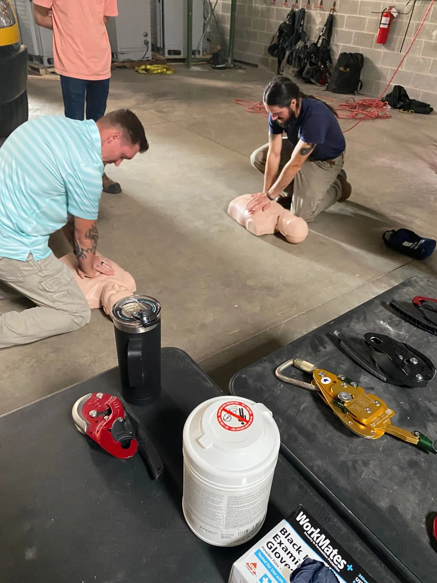 Crew members practicing CPR on training manikins